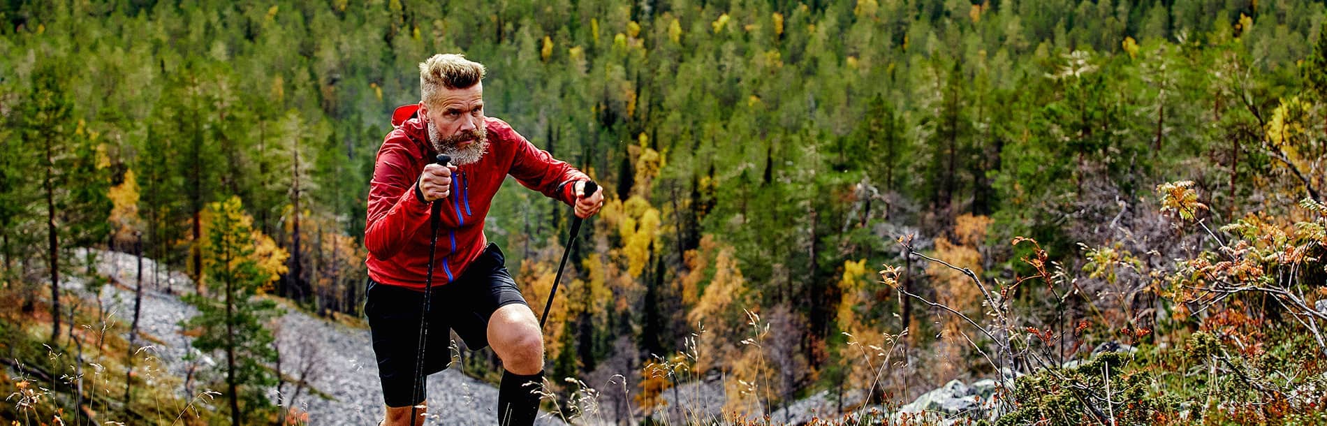 man hiking up a hill