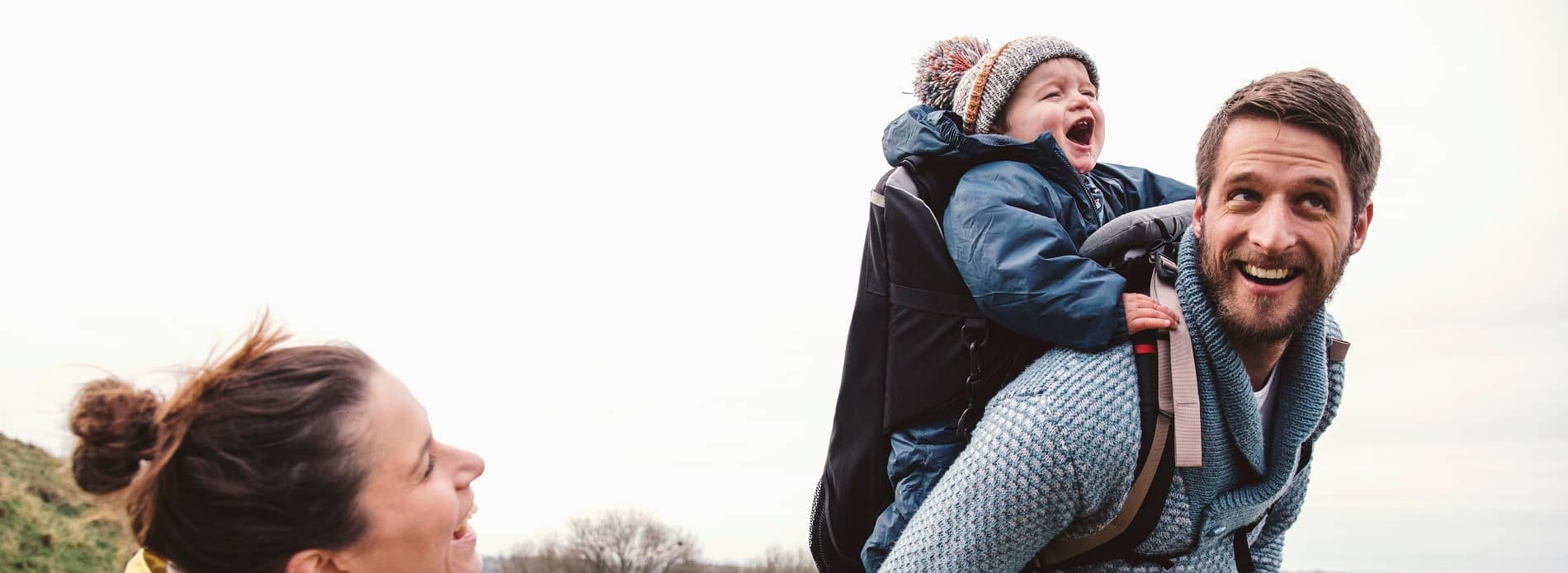 Couple out for a hike with their baby in a carrier