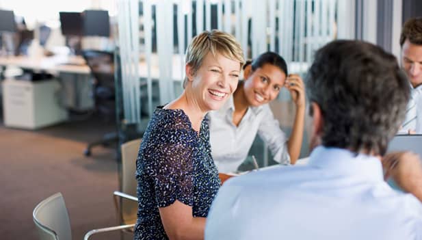 woman smiling in team meeting