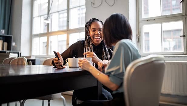 female colleagues talking in break room