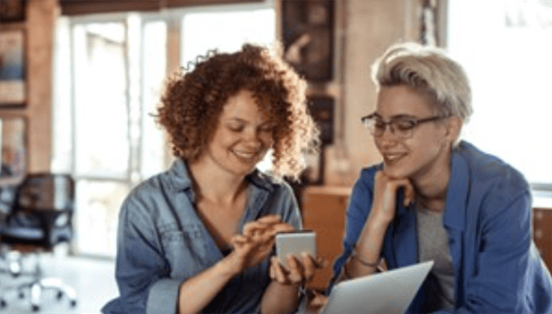 2 women collaborating using tablet computer