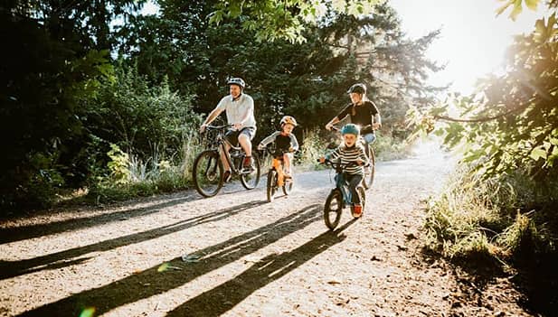 family cycling together