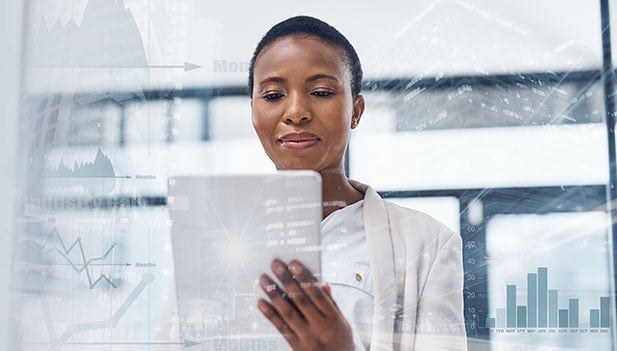 woman looking at tablet computer with futuristic background