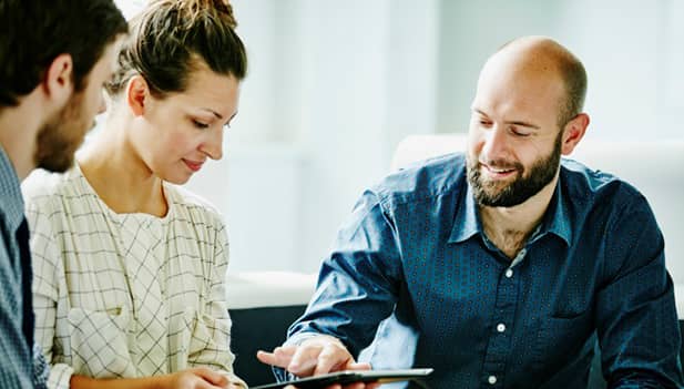 3 colleagues collaborating over tablet computer