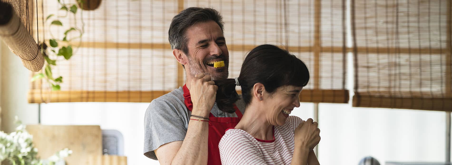 Couple laughing in kitchen