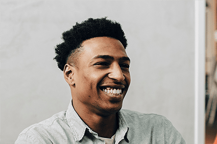 Man laughing in a team meeting