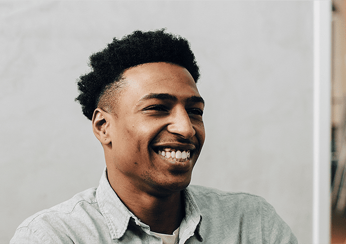 Man laughing in a team meeting
