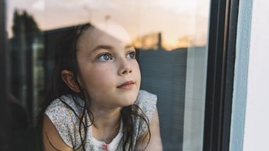 Girl looking out of window