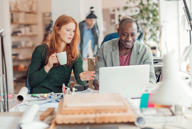 Man and woman looking at laptop