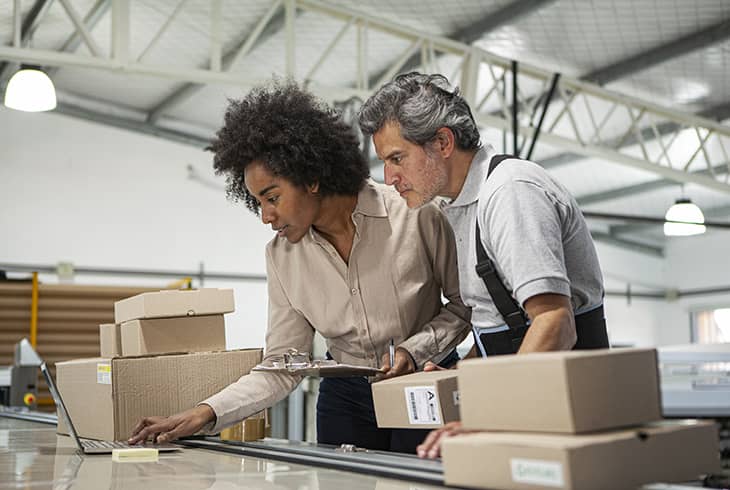 employee and manager in warehouse having conversation