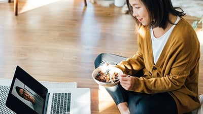 Woman eating cereal while in a Teams meeting