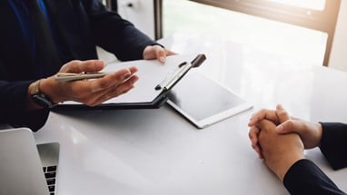 An interview taking place at a desk
