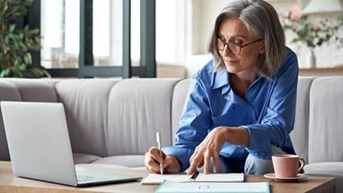 Woman writing on a notepad