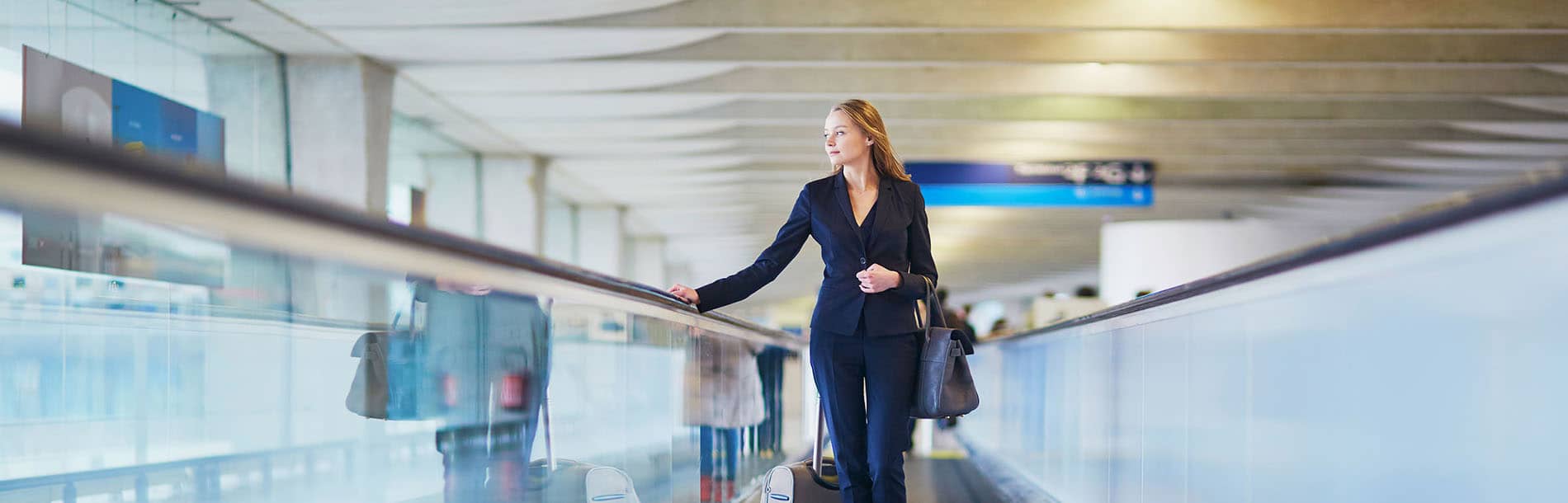 Woman standing on travellator in airport