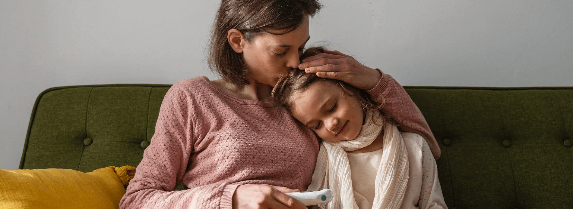 mother kissing daughter